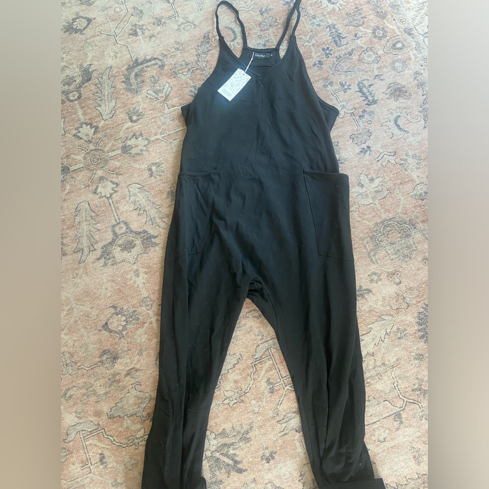 Black jumpsuit with pockets, tags still attached.
